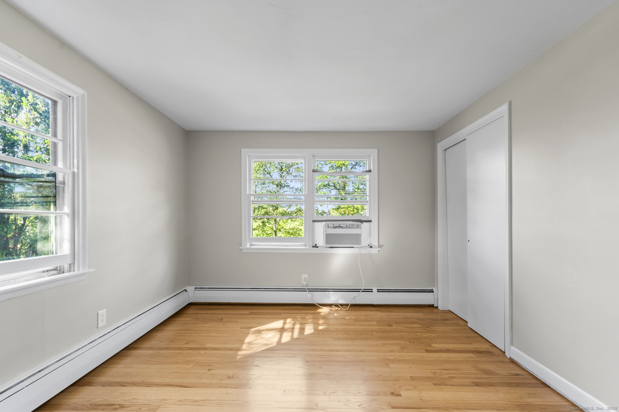 779 Bridge Street Suffield, CT 06078 - Photo 25 of 35 an empty room with wooden floor and windows