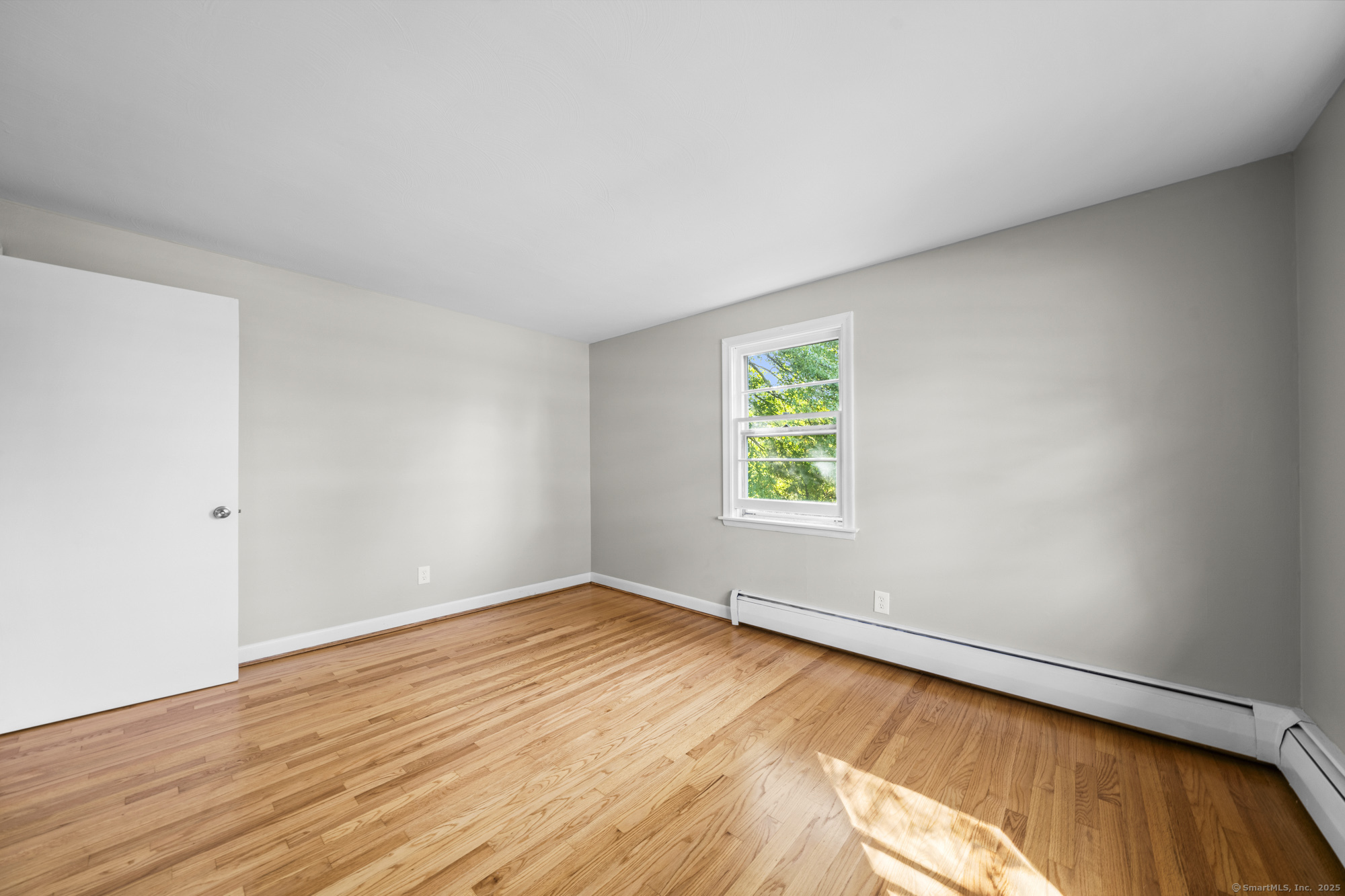 779 Bridge Street Suffield, CT 06078 - Photo 26 of 35 an empty room with wooden floor and windows