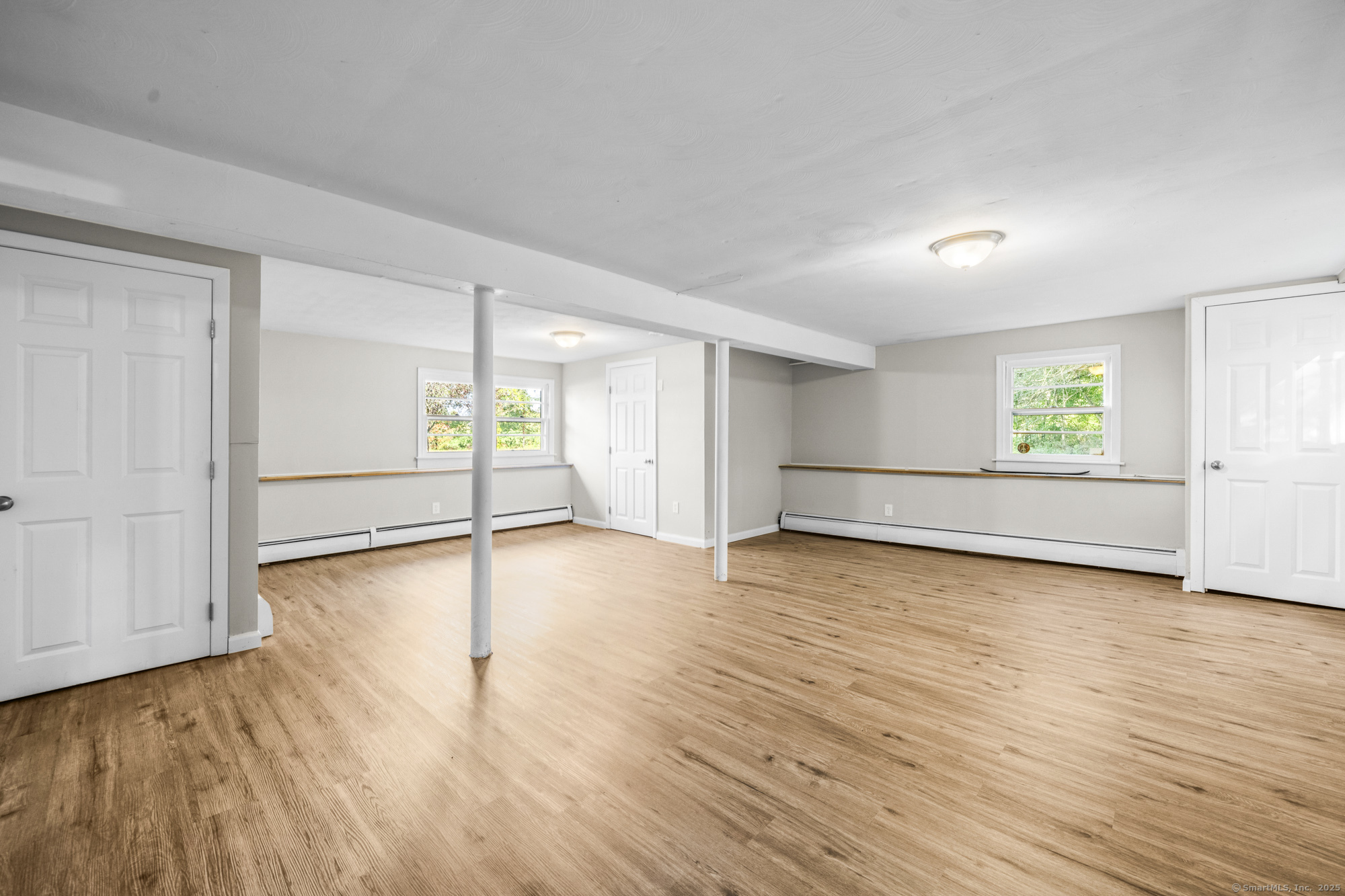 779 Bridge Street Suffield, CT 06078 - Photo 27 of 35 an empty room with wooden floor and windows