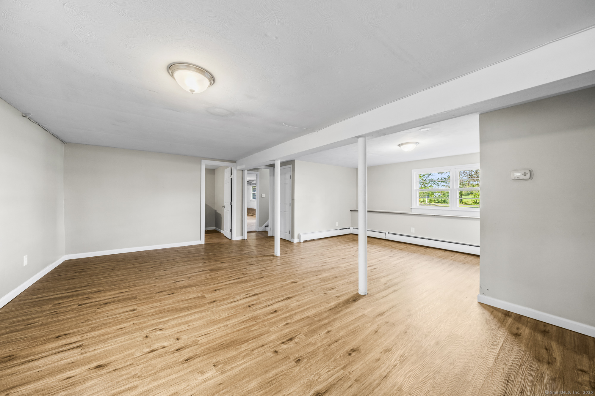 779 Bridge Street Suffield, CT 06078 - Photo 28 of 35 a view of an empty room with window and wooden floor