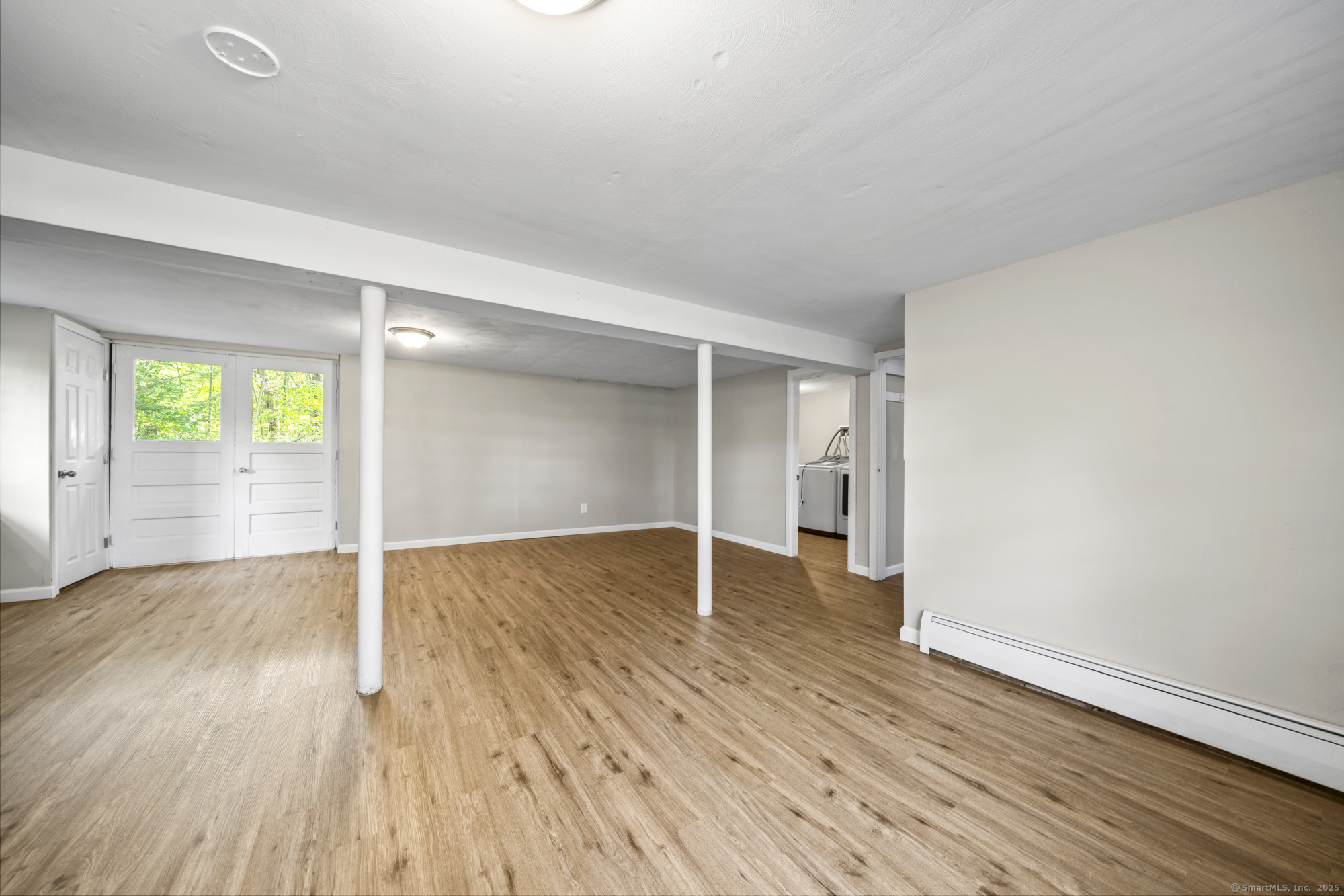 779 Bridge Street Suffield, CT 06078 - Photo 30 of 35 an empty room with wooden floor and windows