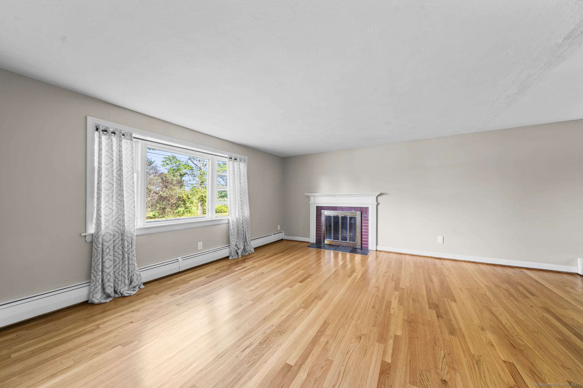 779 Bridge Street Suffield, CT 06078 - Photo 5 of 35 an empty room with wooden floor and windows