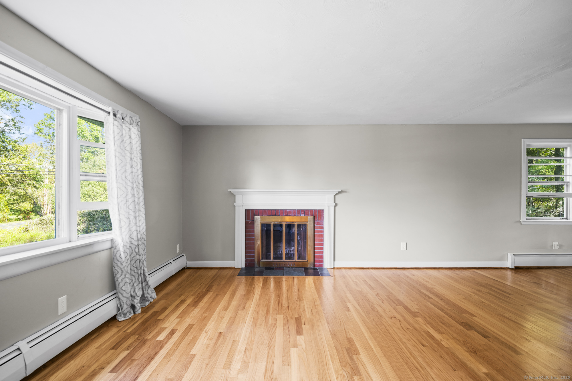 779 Bridge Street Suffield, CT 06078 - Photo 6 of 35 an empty room with wooden floor and windows