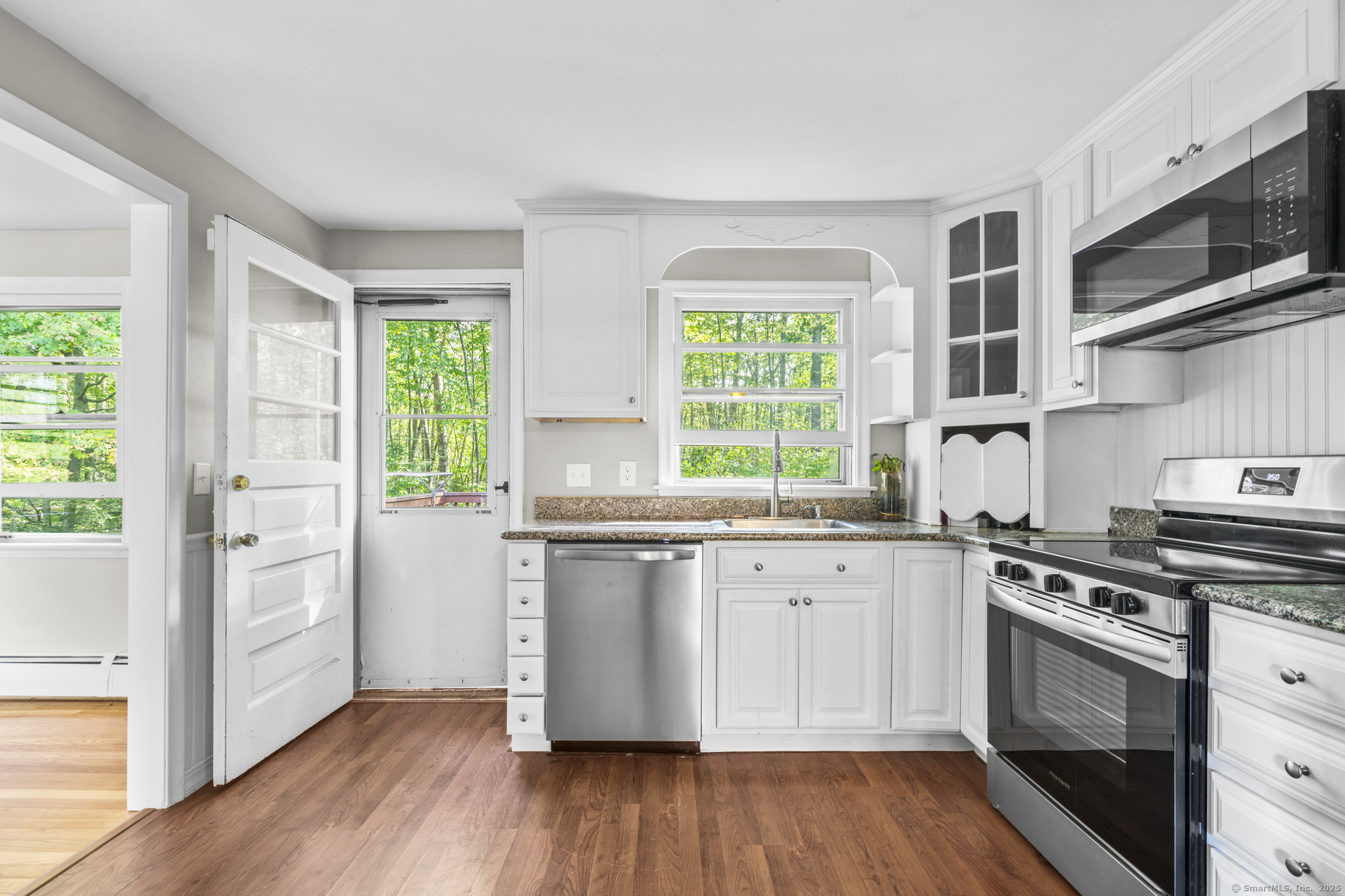779 Bridge Street Suffield, CT 06078 - Photo 9 of 35 a kitchen with stainless steel appliances a stove a sink and a hard wood floors