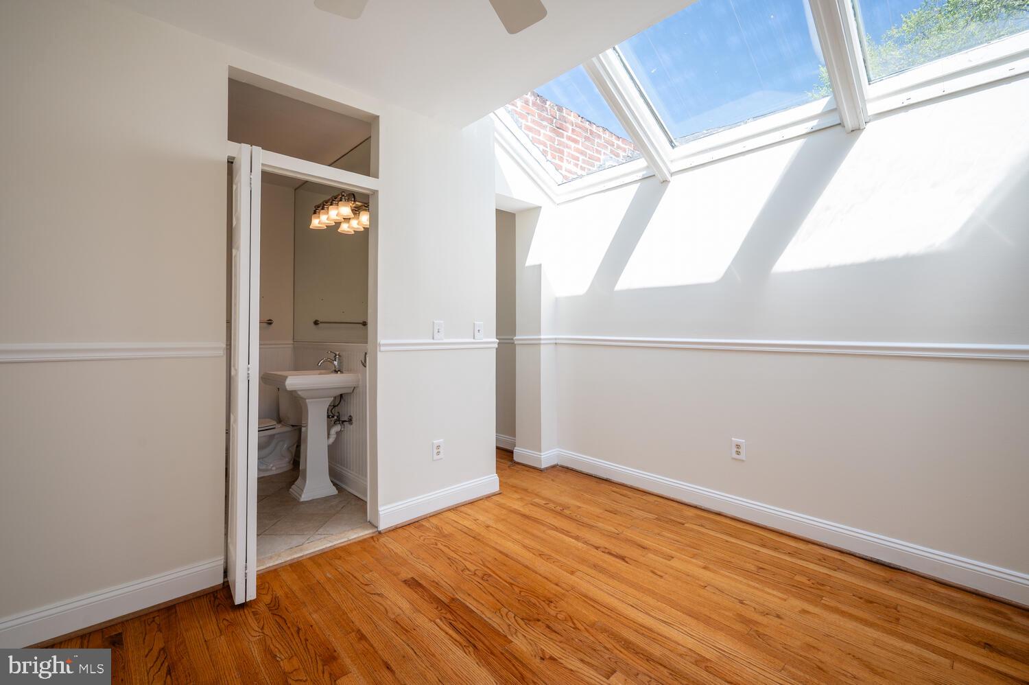 613 14th Place Northeast Washington, DC 20002 - Photo 15 of 31 a view of a room with wooden floor and next to a window