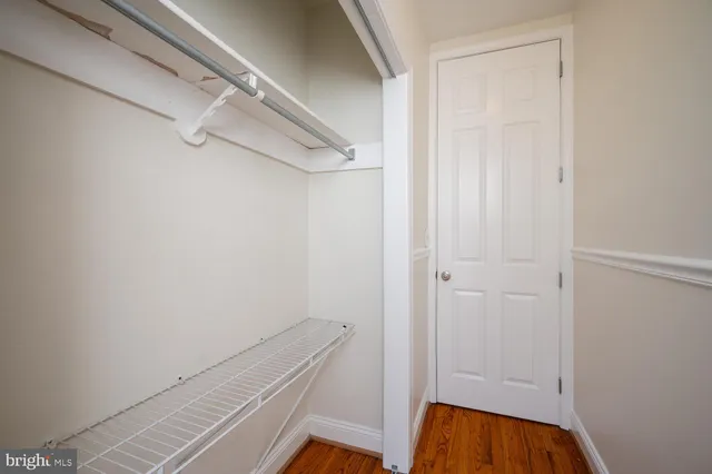 an empty room with wooden floor and closet
