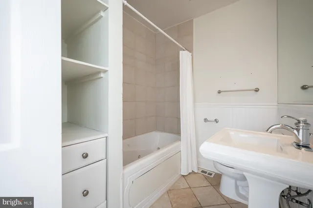 a bathroom with a sink toilet and mirror