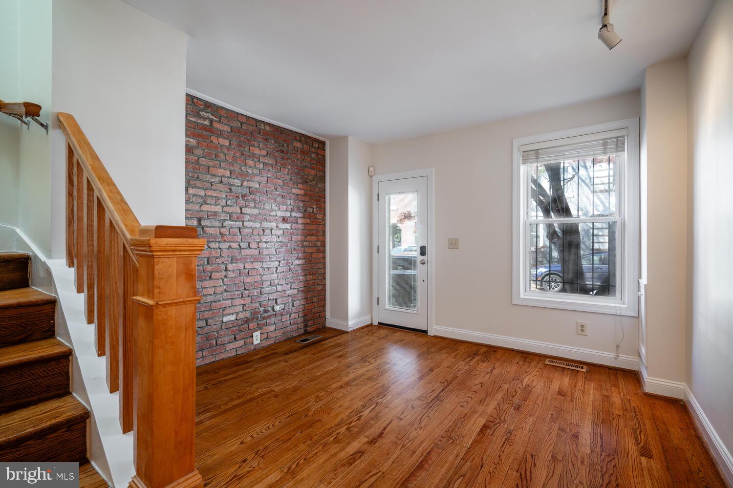 613 14th Place Northeast Washington, DC 20002 - Photo 2 of 31 a view of an empty room with wooden floor and a window