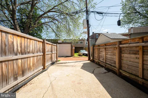 a view of a house with wooden fence