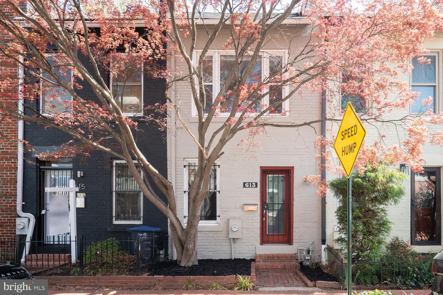 613 14th Place Northeast Washington, DC 20002 - Photo 30 of 31 a yellow building with trees in front of it