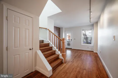 a view of an entryway with wooden floor