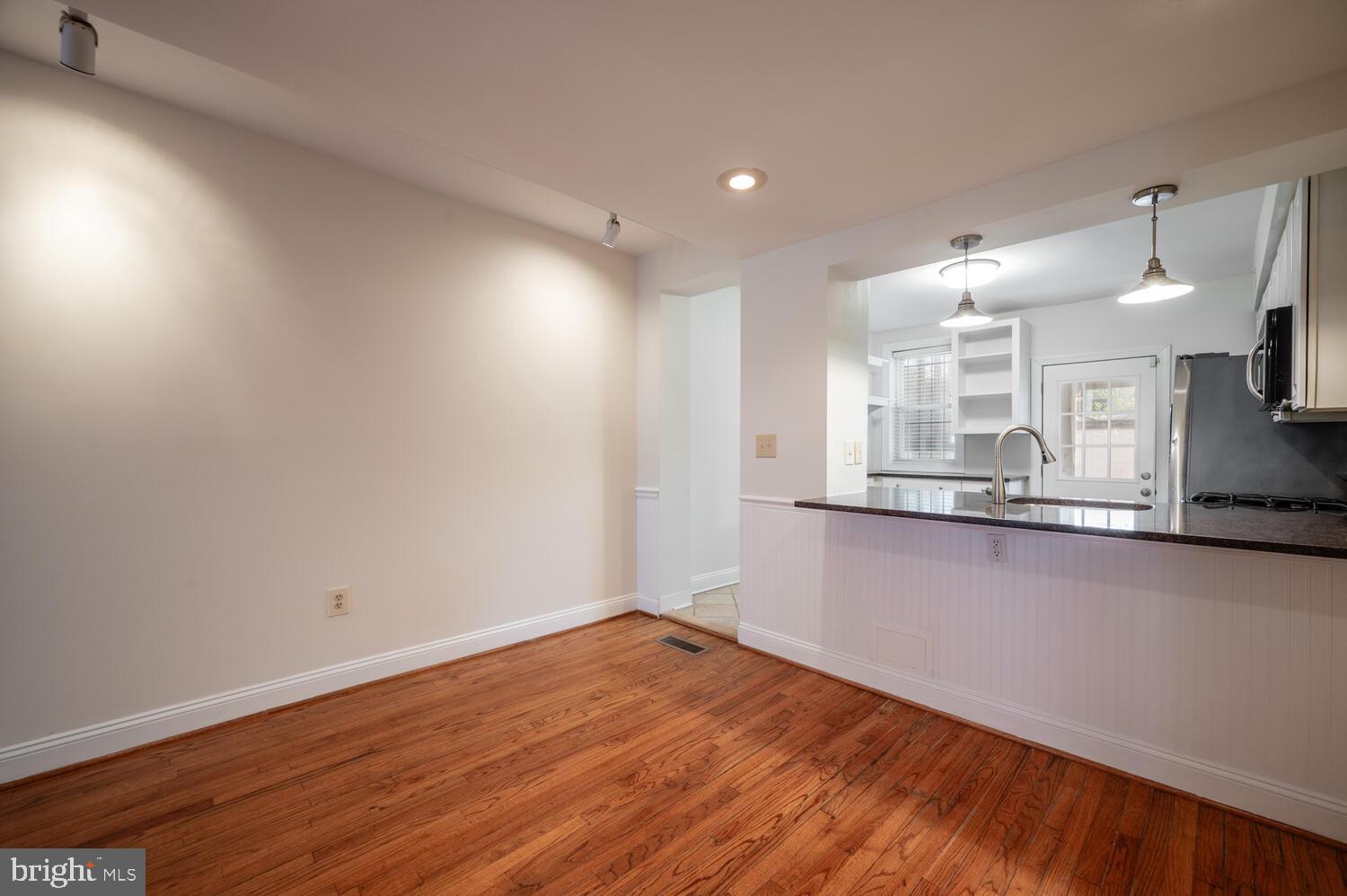 613 14th Place Northeast Washington, DC 20002 - Photo 6 of 31 an empty room with wooden floor and windows