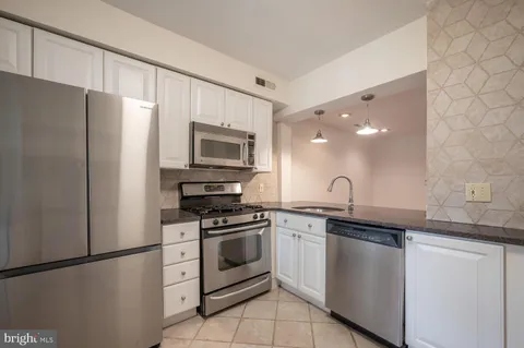 a kitchen with a sink stove and refrigerator