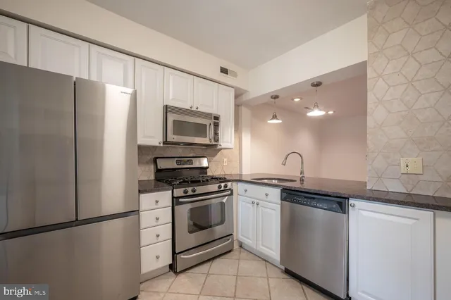 a kitchen with a sink stove and refrigerator