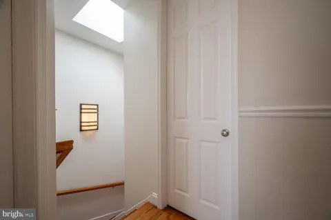 a bathroom with a granite countertop sink a toilet a mirror and shower
