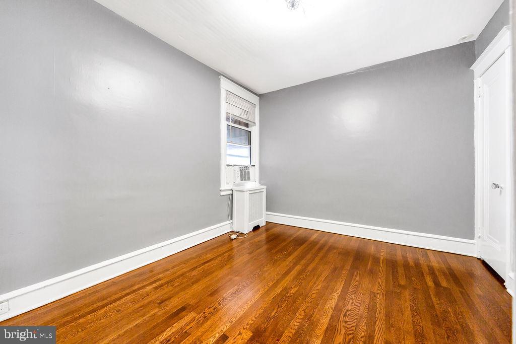 214 Kingston Road Upper Darby, PA 19082 - Photo 15 of 23 an empty room with wooden floor and windows