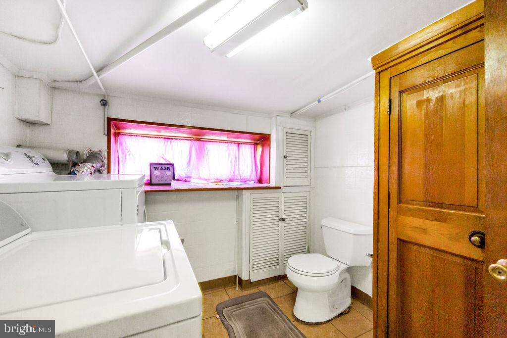 214 Kingston Road Upper Darby, PA 19082 - Photo 21 of 23 a bathroom with a toilet sink and mirror