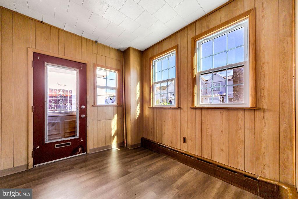214 Kingston Road Upper Darby, PA 19082 - Photo 3 of 23 a view of an empty room with wooden floor and a window