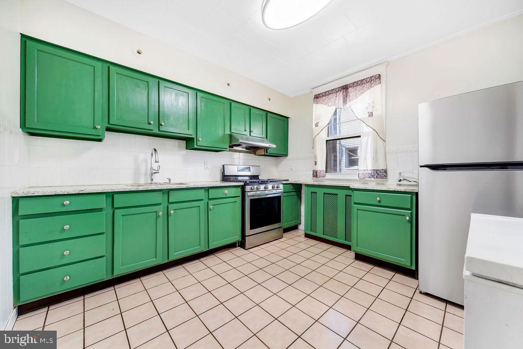 214 Kingston Road Upper Darby, PA 19082 - Photo 9 of 23 a kitchen with a sink cabinets and a window