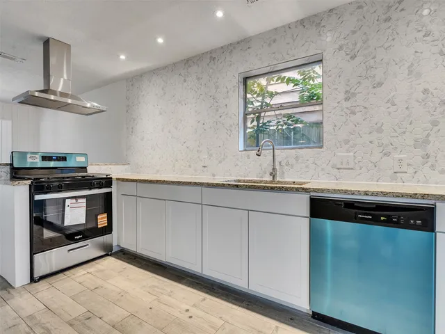a view of a kitchen with a stove cabinets and wooden floor