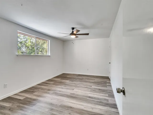 an aerial view of ocean and residential houses with outdoor space