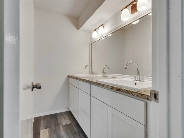an aerial view of residential houses with outdoor space and trees all around