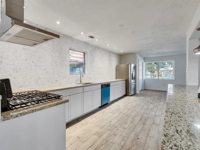 a view of an empty room with a fireplace and a window