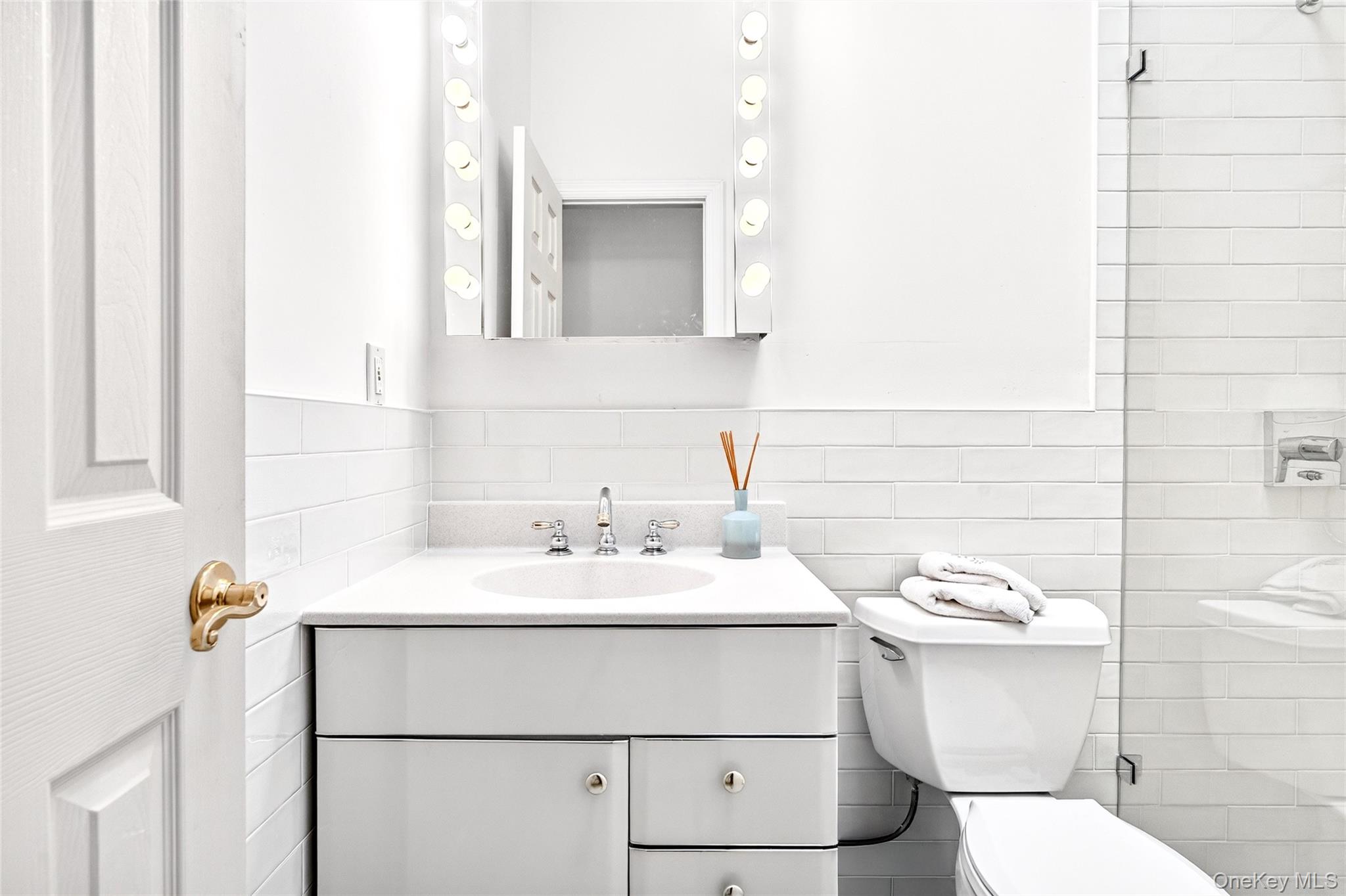 3334 Country Club Road Bronx, NY 10465 - Photo 27 of 49 Full bath featuring vanity, tile walls, a tile shower, and decorative backsplash