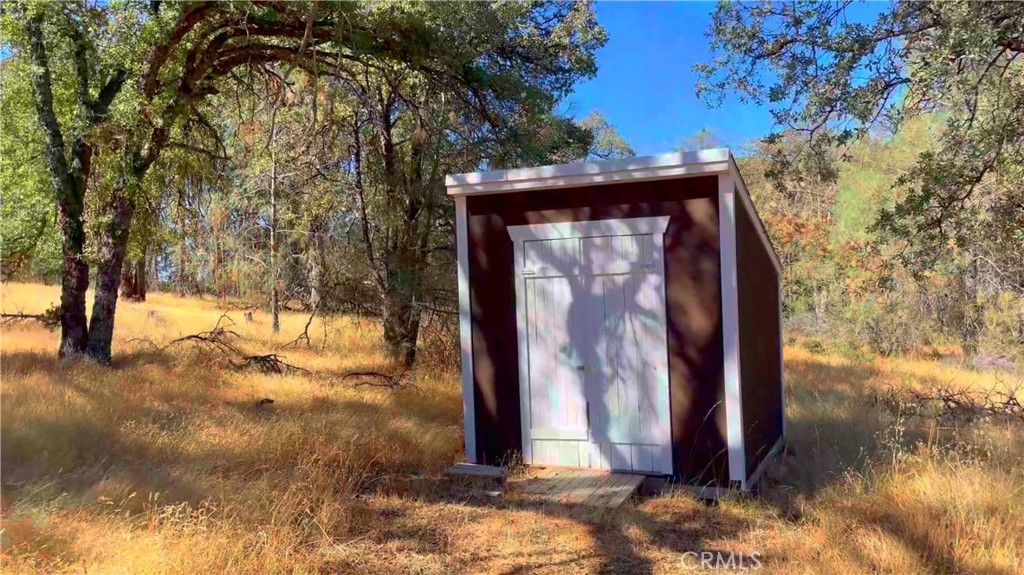 5341 Paddy Hill Road Mariposa, CA 95338 - Photo 9 of 20 a view of a wooden house with a large tree