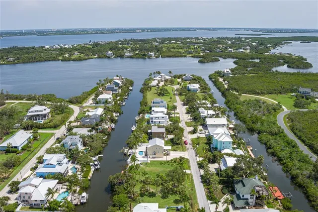 an aerial view of lake residential houses with outdoor space and ocean view