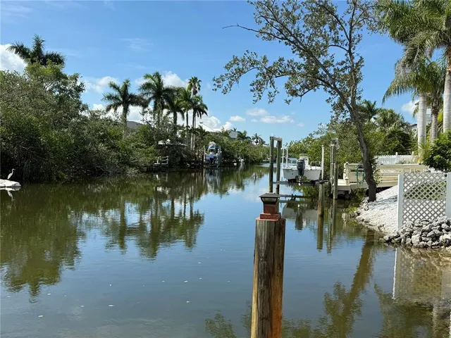 a view of a lake with houses in all around