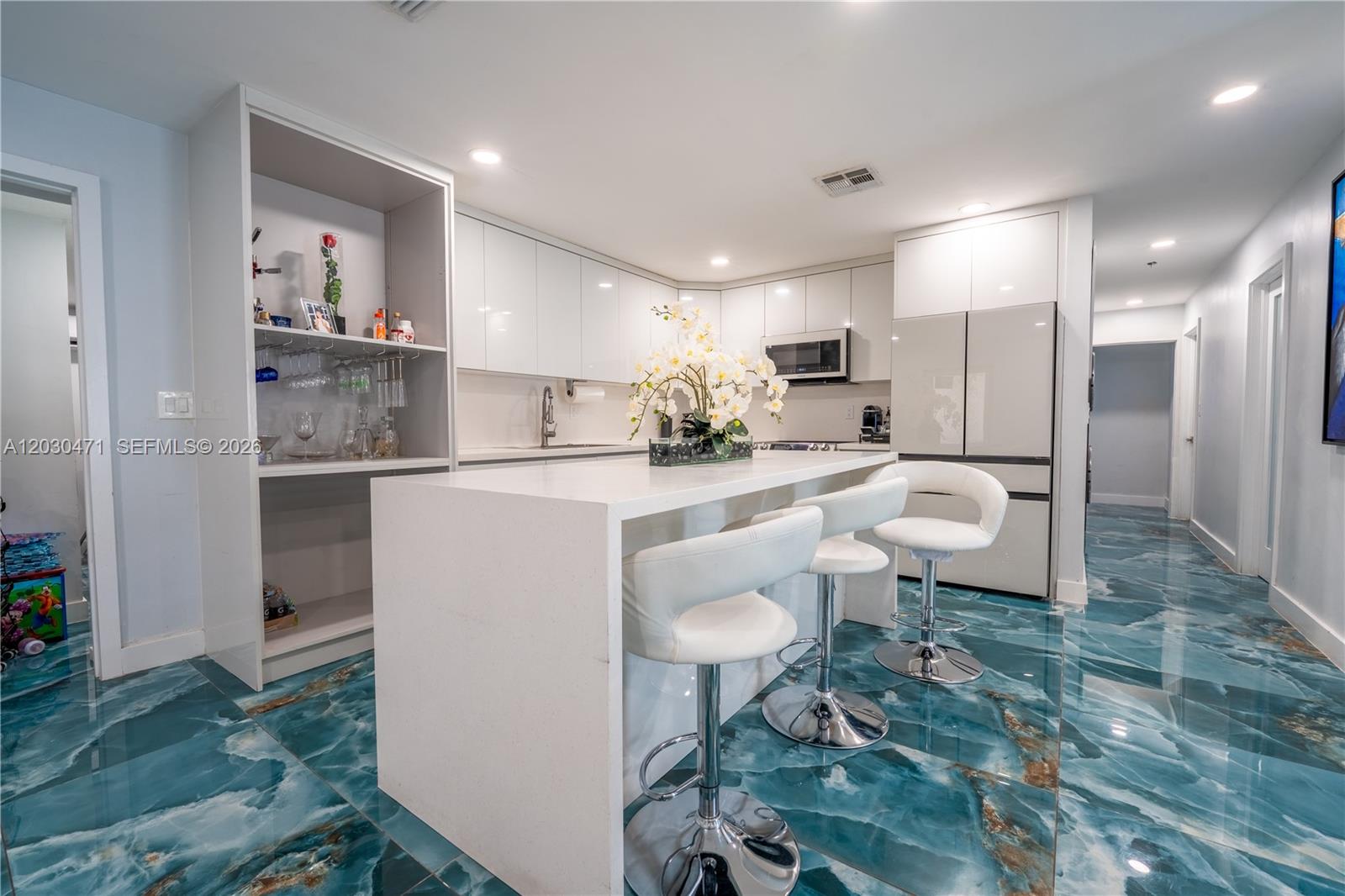 11851 Southwest 181st Street Miami, FL 33177 - Photo 17 of 25 a kitchen with kitchen island a sink stove and refrigerator