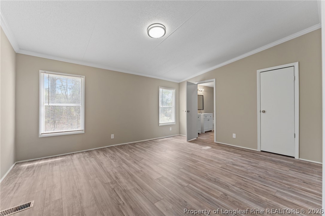 515 Mt Zion Road Red Springs, NC 28377 - Photo 13 of 50 an empty room with wooden floor and windows