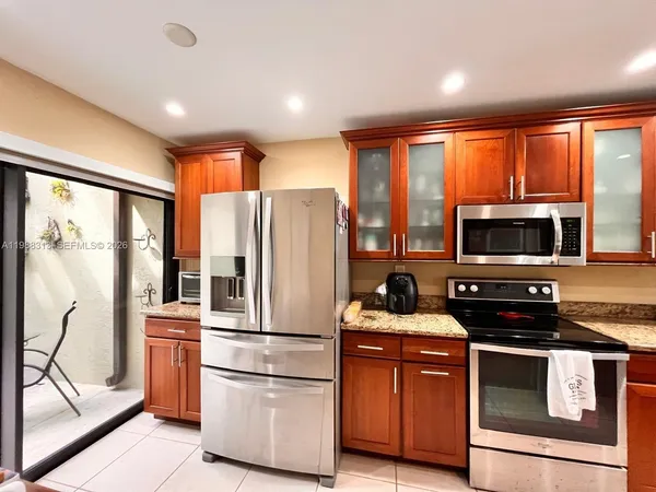 a kitchen with stainless steel appliances a refrigerator stove and microwave