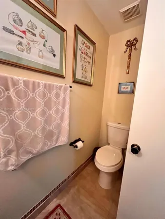 a white toilet sitting next to a shower curtain