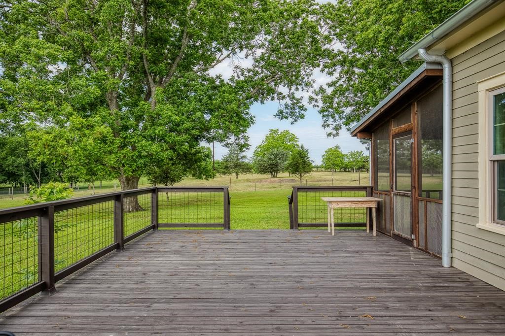 6900 Schroeder Road Brenham, TX 77833 - Photo 14 of 31 a view of park with wooden deck and a backyard