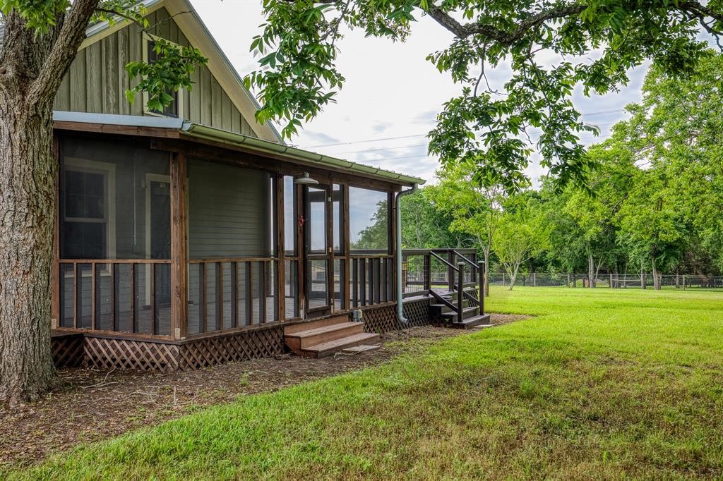 6900 Schroeder Road Brenham, TX 77833 - Photo 16 of 31 a view of backyard with deck and outdoor seating