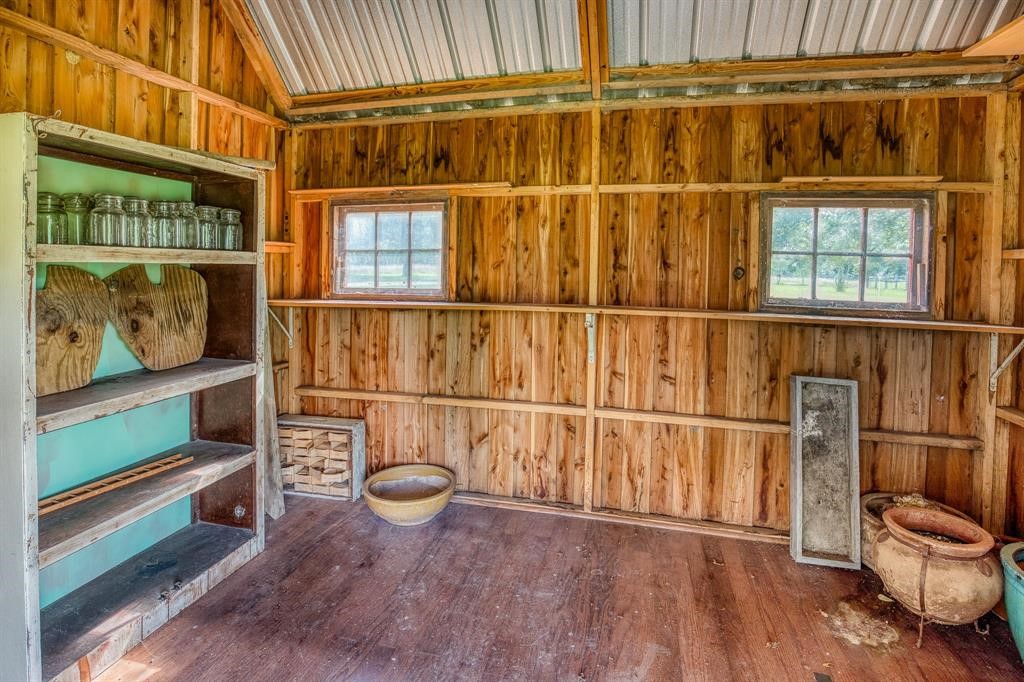 6900 Schroeder Road Brenham, TX 77833 - Photo 29 of 31 a view of a room with wooden floor and windows