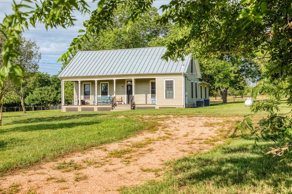 6900 Schroeder Road Brenham, TX 77833 - Photo 5 of 31 a front view of a house with a yard