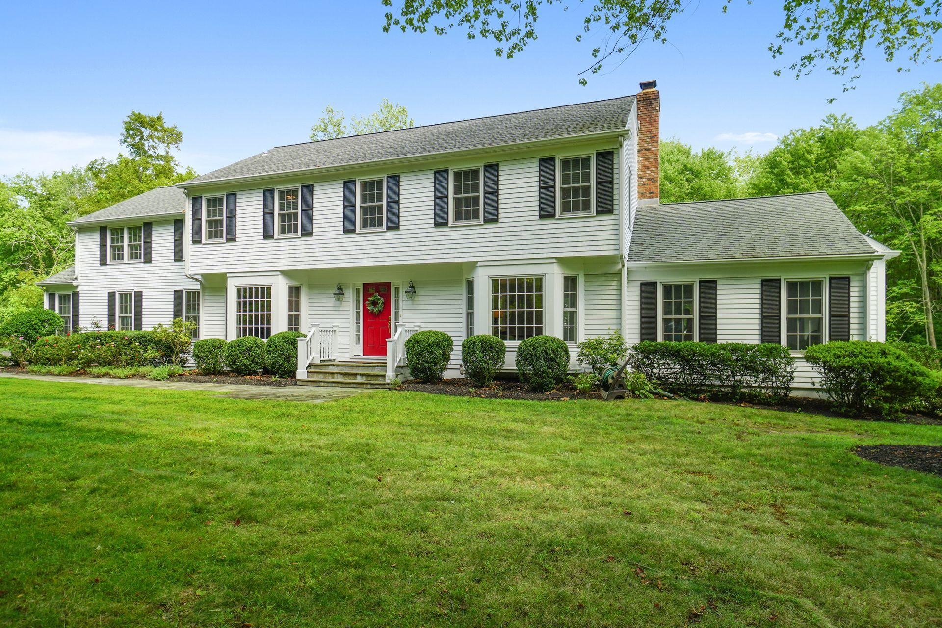 a front view of a house with garden and porch
