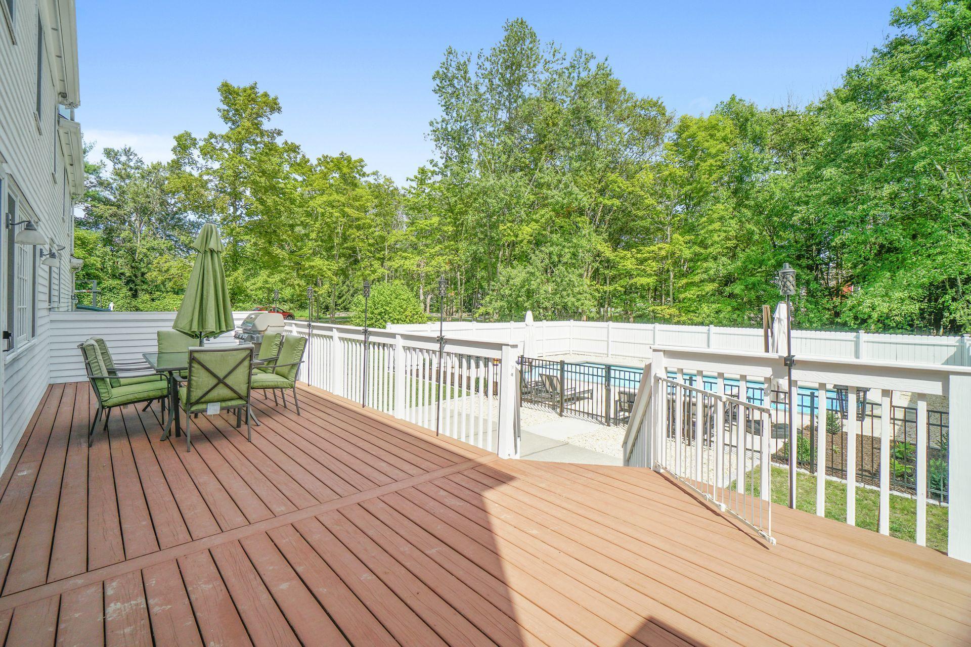 231 Ponus Ridge Road New Canaan, CT 06840 - Photo 14 of 37 a balcony with wooden floor table and chairs