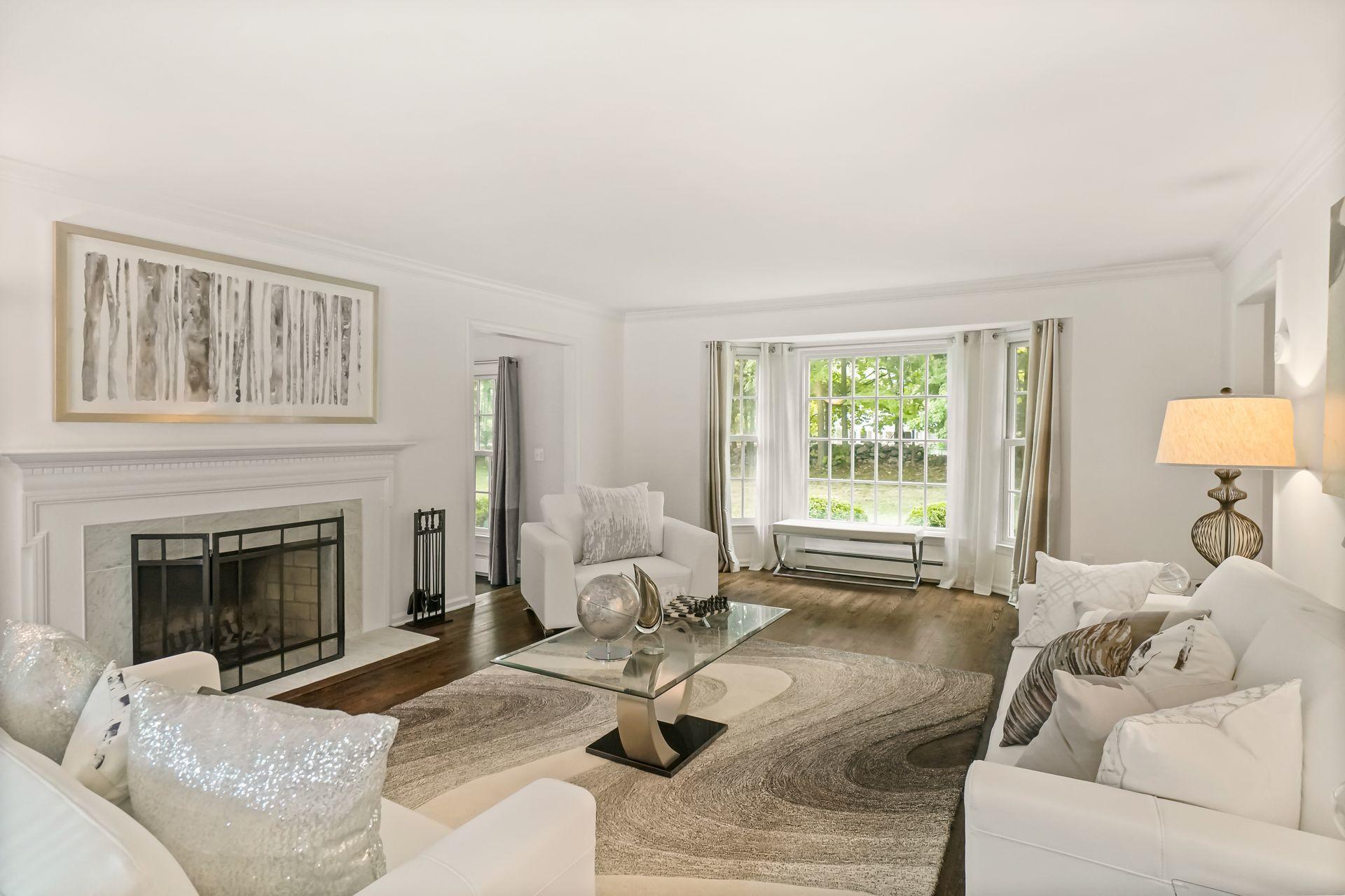 231 Ponus Ridge Road New Canaan, CT 06840 - Photo 3 of 37 a living room with furniture a fireplace and a large window
