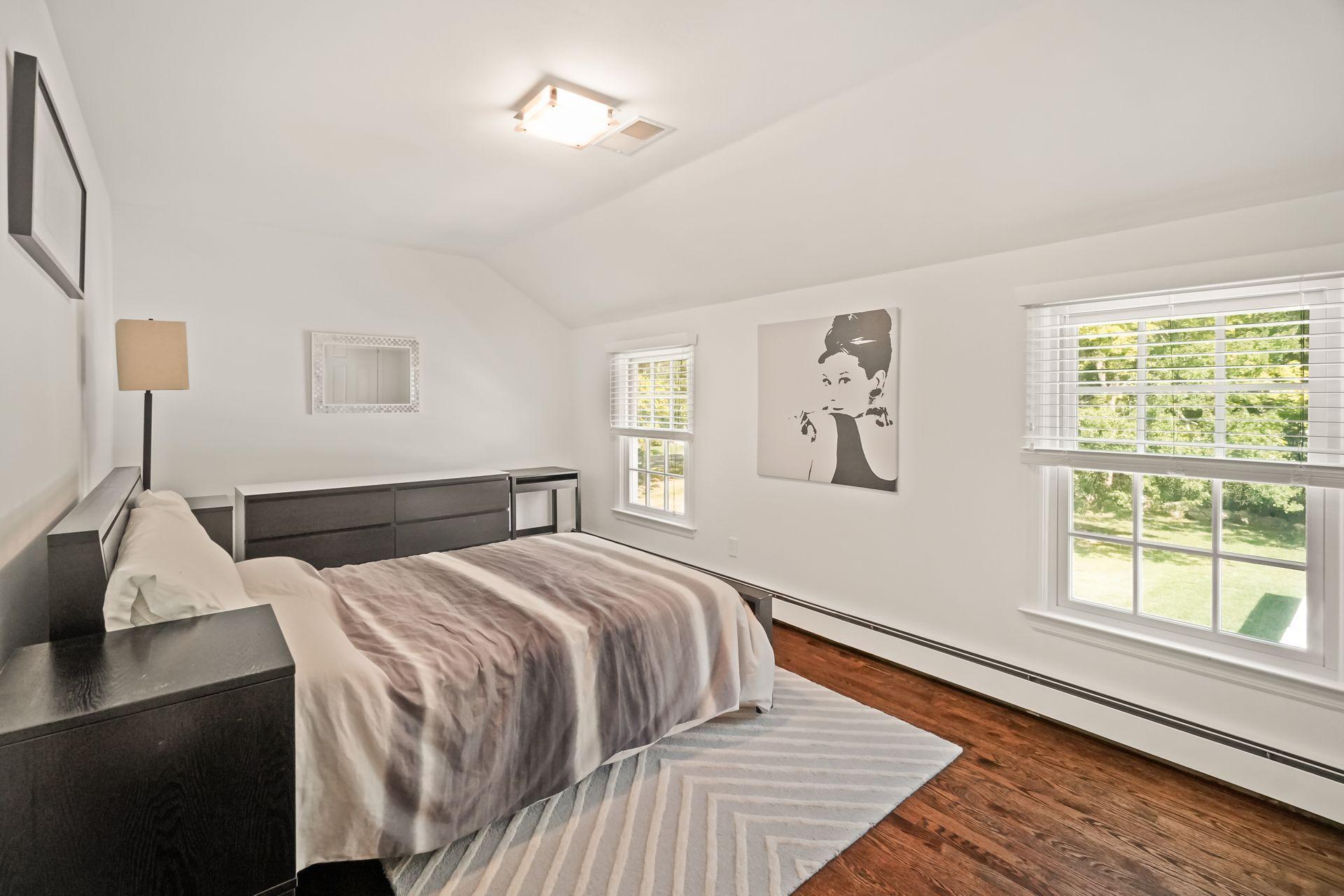 231 Ponus Ridge Road New Canaan, CT 06840 - Photo 22 of 37 a bedroom with a large bed and a window