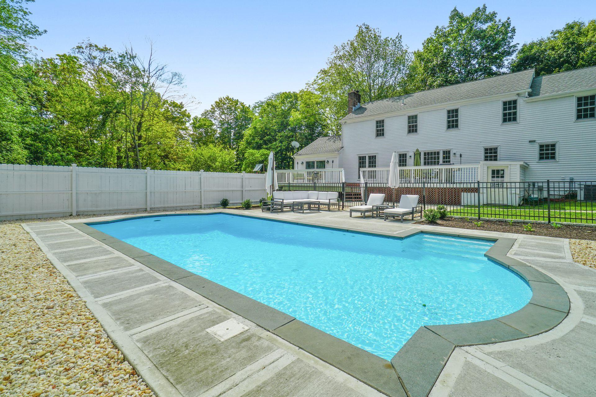 231 Ponus Ridge Road New Canaan, CT 06840 - Photo 29 of 37 a view of a house with swimming pool and sitting area