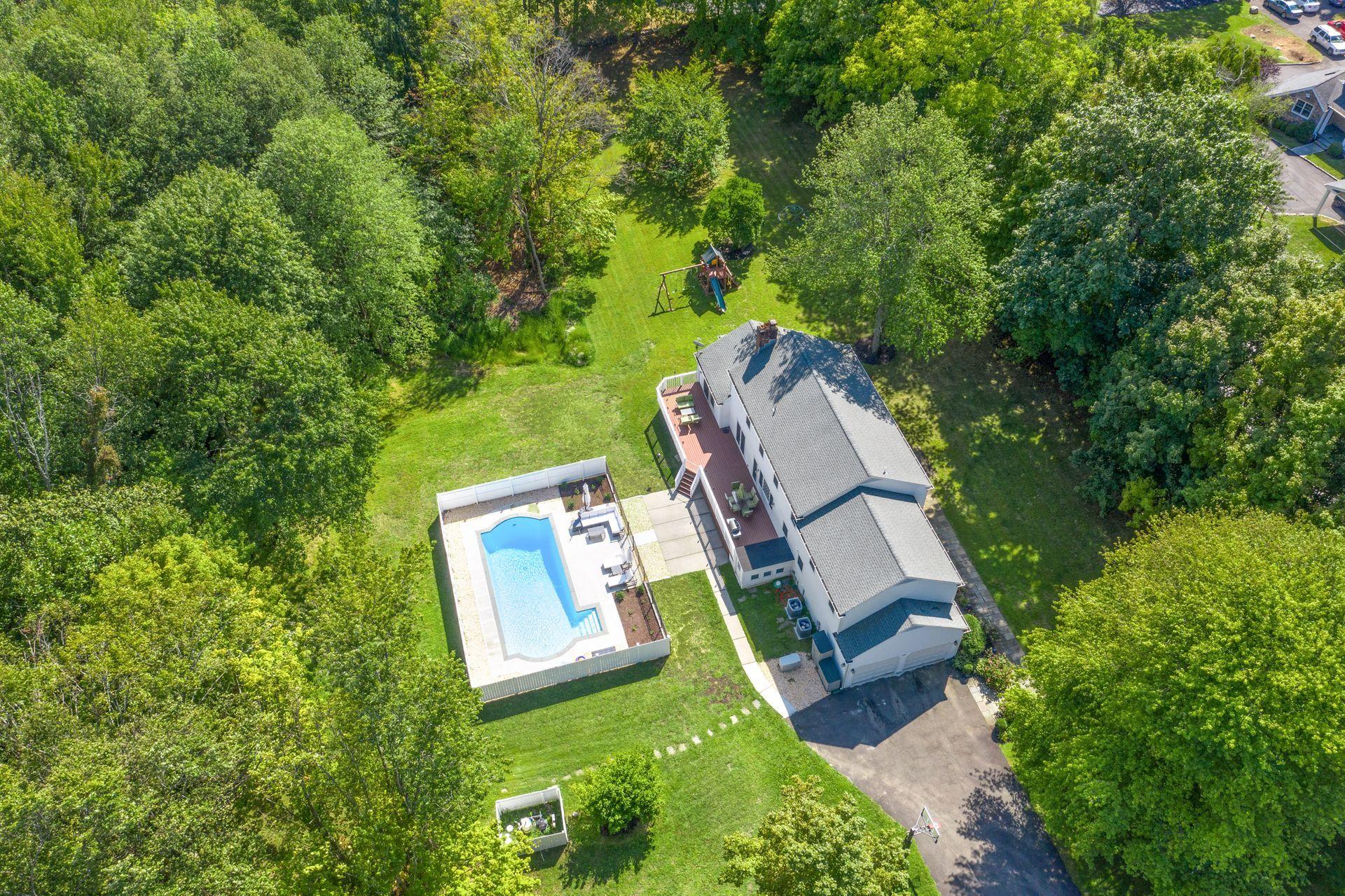 231 Ponus Ridge Road New Canaan, CT 06840 - Photo 33 of 37 an aerial view of a house with a yard