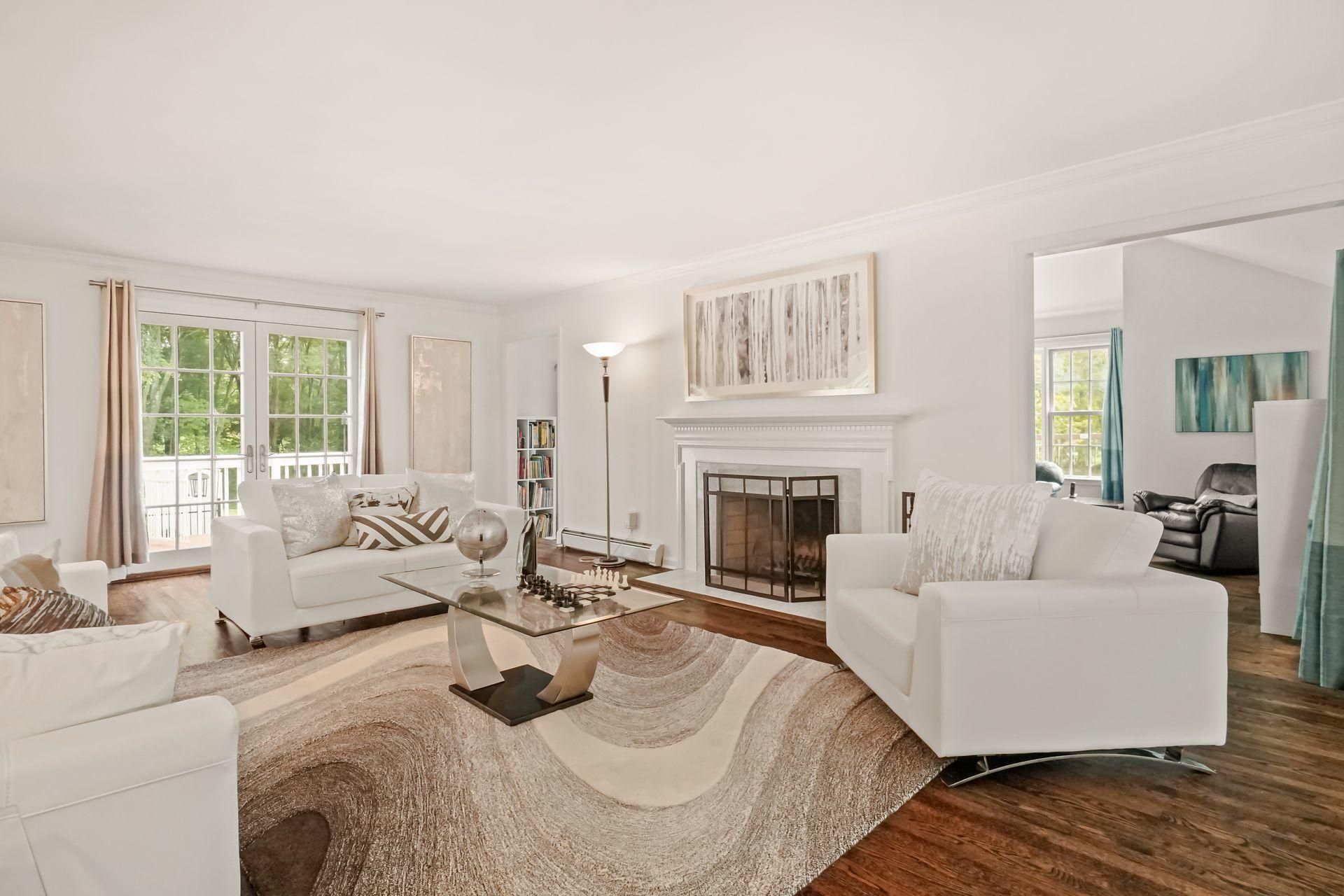 231 Ponus Ridge Road New Canaan, CT 06840 - Photo 5 of 37 a living room with furniture and a fireplace