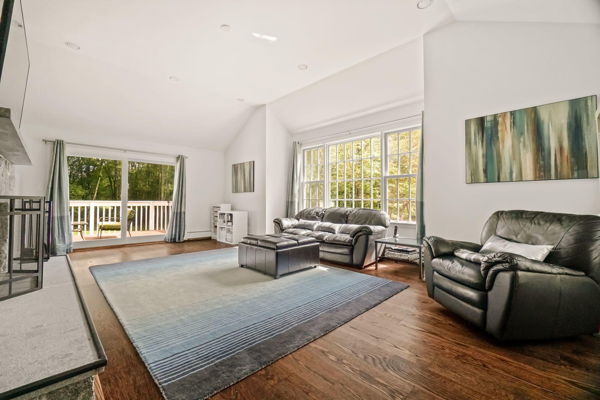 231 Ponus Ridge Road New Canaan, CT 06840 - Photo 6 of 37 a living room with furniture and a large window