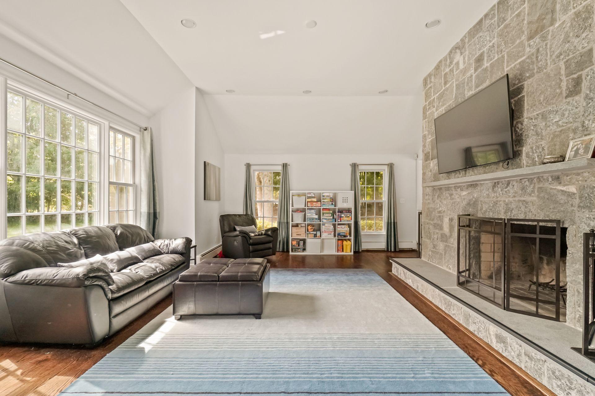 231 Ponus Ridge Road New Canaan, CT 06840 - Photo 7 of 37 a living room with furniture and a fireplace