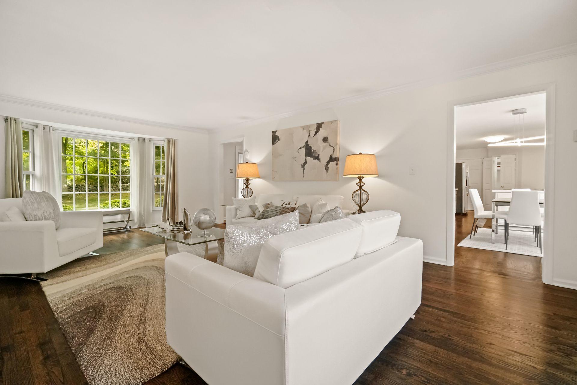 231 Ponus Ridge Road New Canaan, CT 06840 - Photo 8 of 37 a living room with furniture and a large window