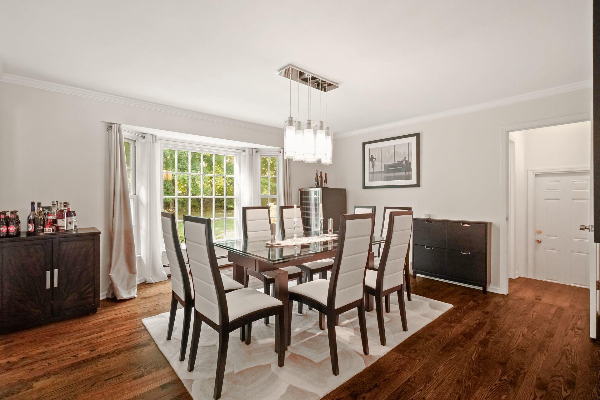 231 Ponus Ridge Road New Canaan, CT 06840 - Photo 9 of 37 a view of a dining room with furniture window and wooden floor